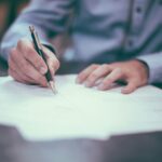 How to Transfer Investment Property into an LLC in Florida: Updated 2026 Guide man writing on paper